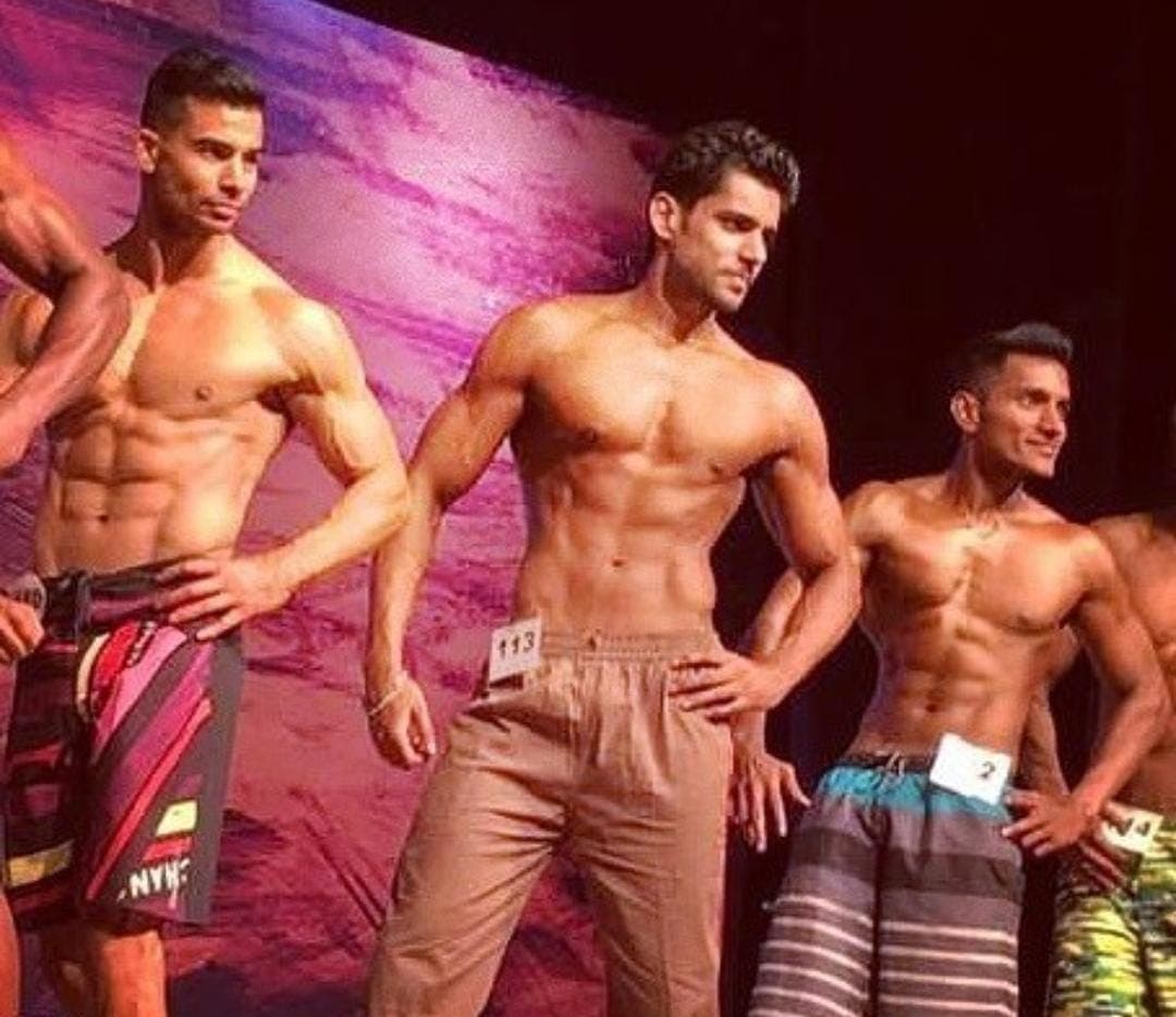 Abhinav Anand on stage during a physique competition
